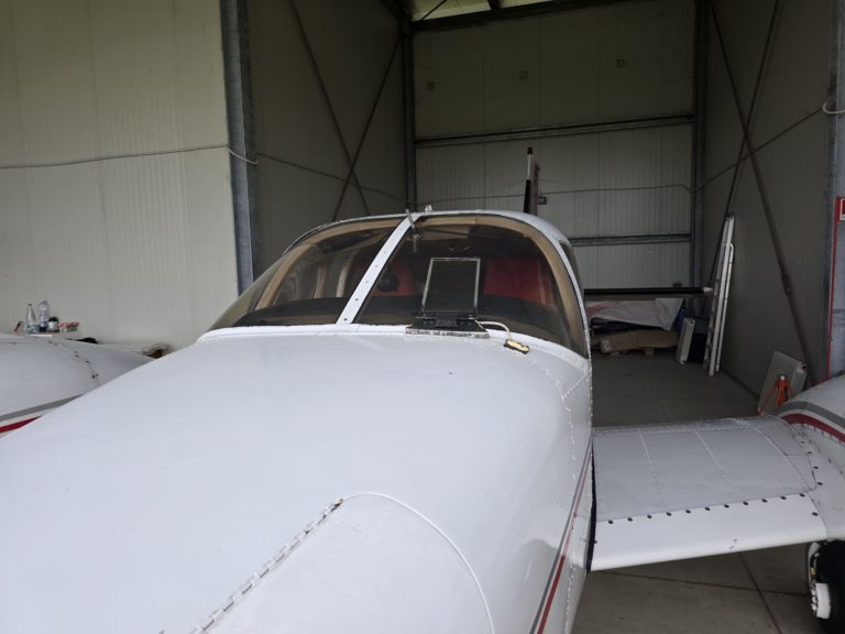 Small aircraft parked inside a hangar