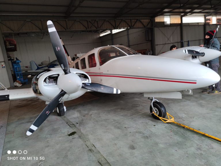 Twin-engine aircraft in a hangar