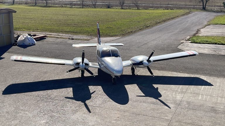 Small propeller airplane parked on tarmac