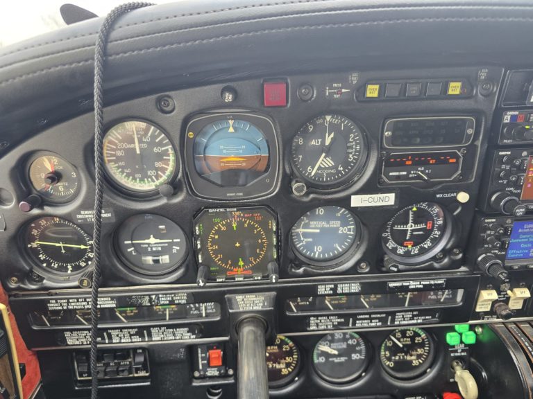 Cockpit instrument panel with various gauges.