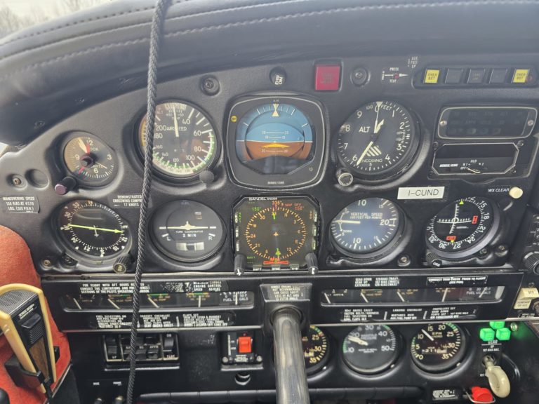 Aircraft cockpit with flight instrument panel gauges.