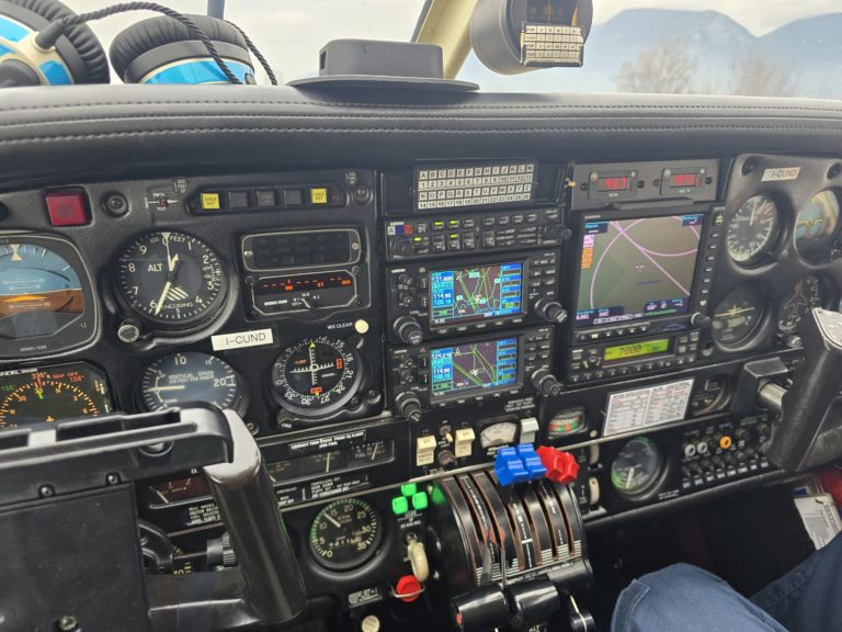 Airplane cockpit with various flight instruments and controls.