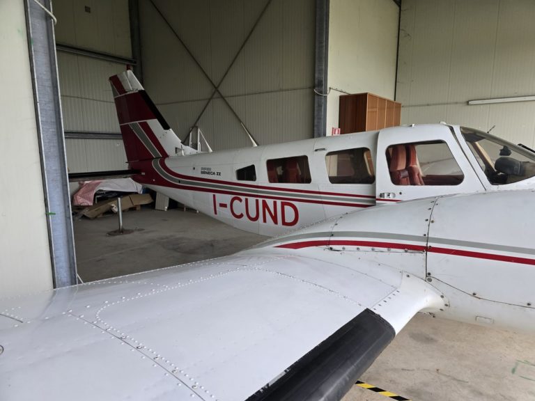 Aircraft parked in a hangar, side view