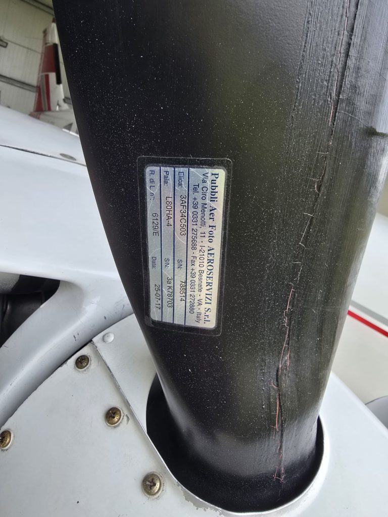 Close-up of a propeller manufacturer's label on an aircraft.