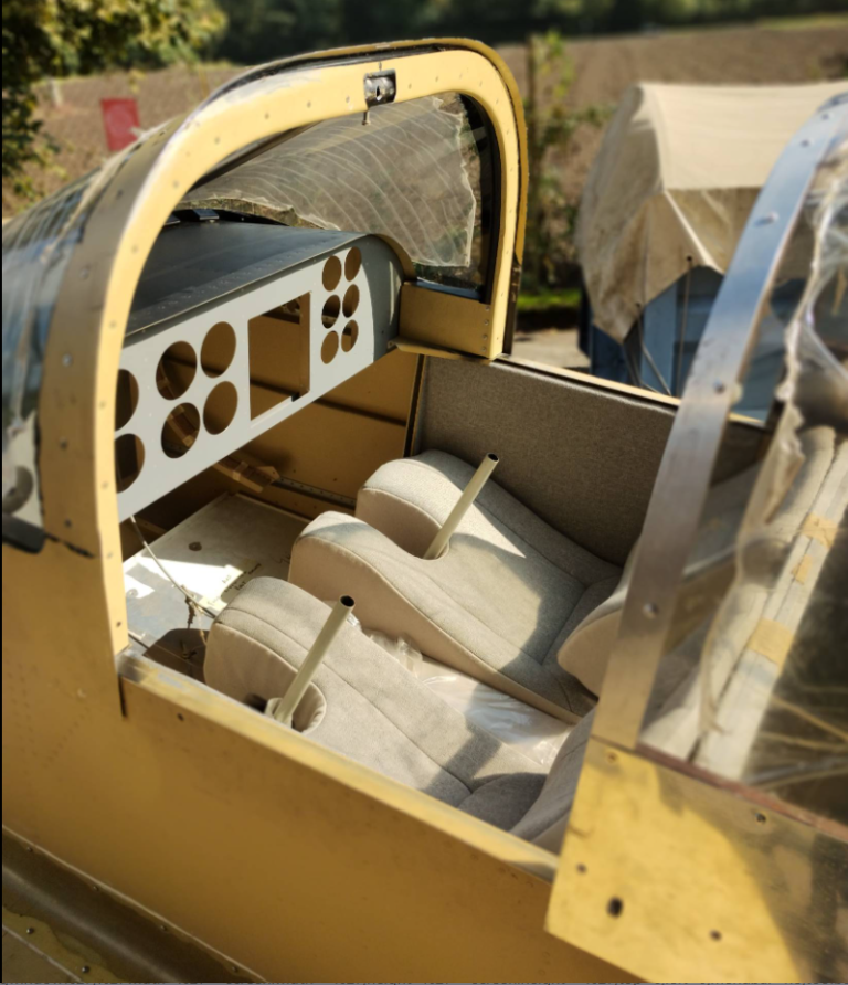 Empty cockpit of small aircraft under sunlight.