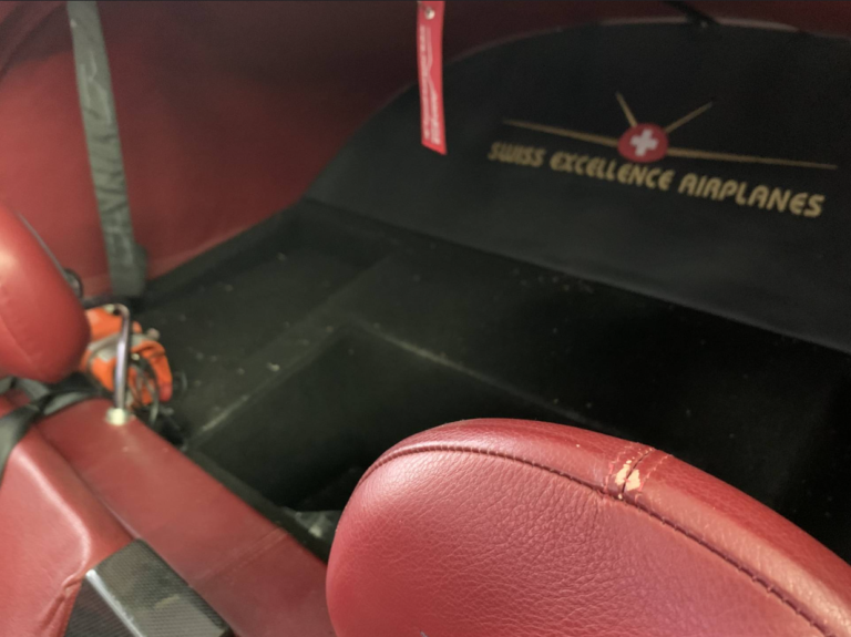 Red airplane interior with Swiss Excellence logo.