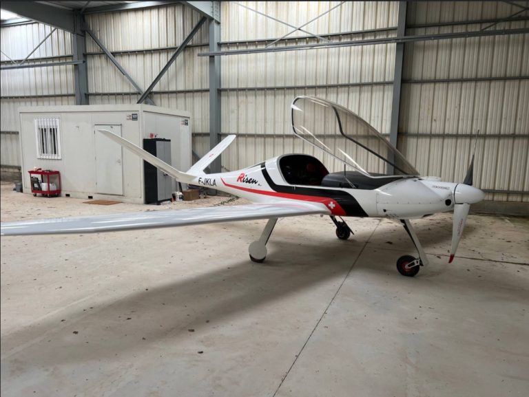 Single-engine aircraft in hangar.