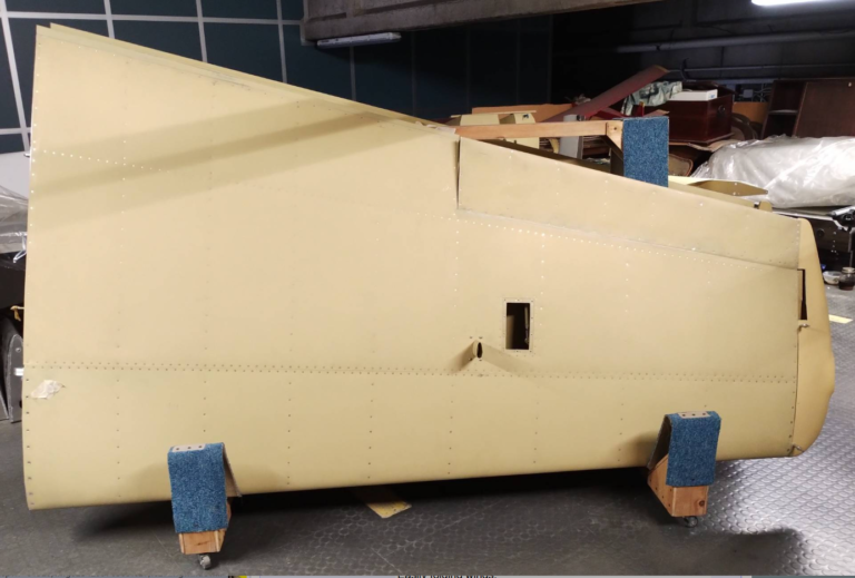 Yellow airplane wing section in storage