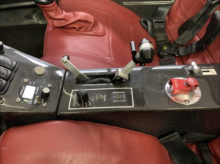 Aircraft cockpit controls and red leather seat