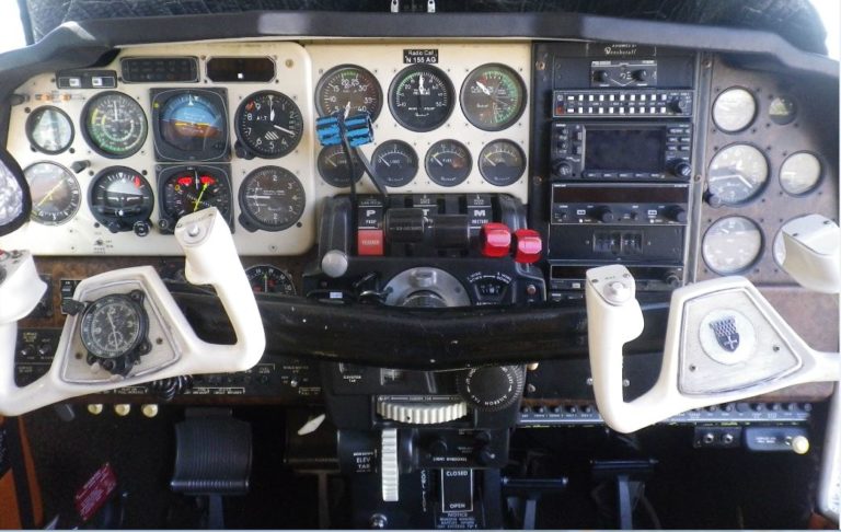 Airplane cockpit with various instruments and controls.