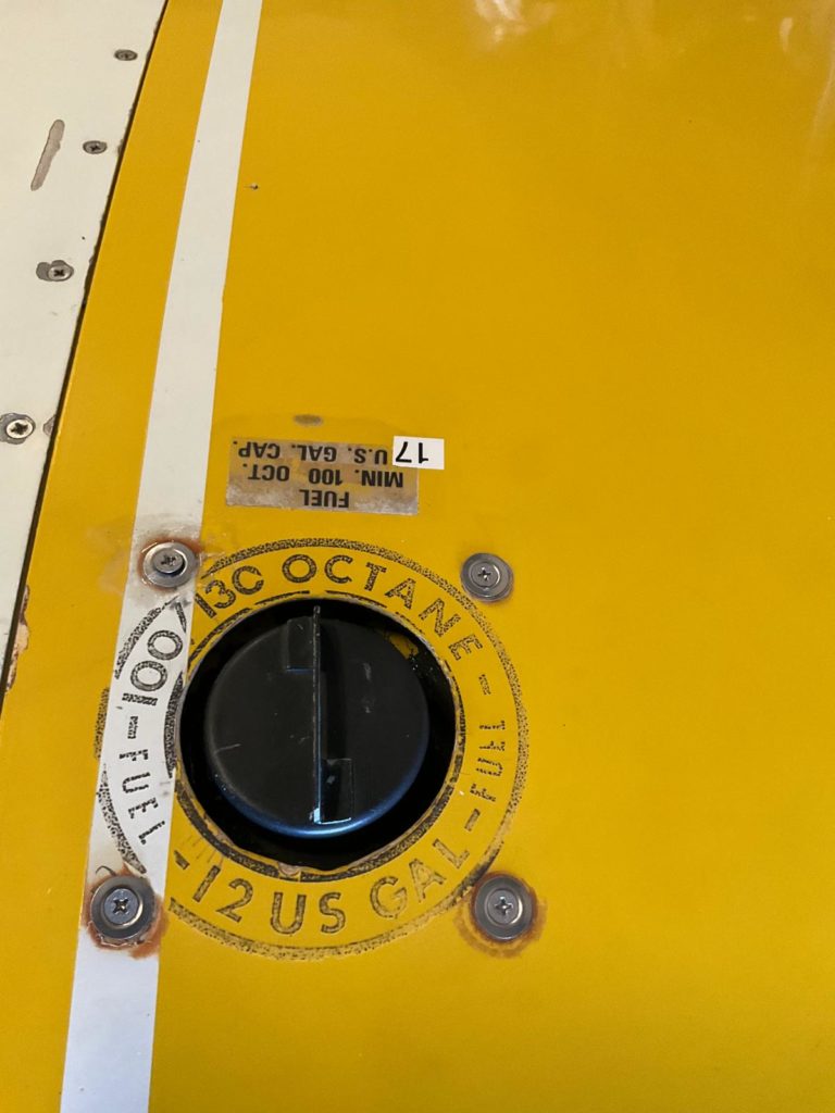 Yellow fuel cap, 100 octane, 12 US gallons