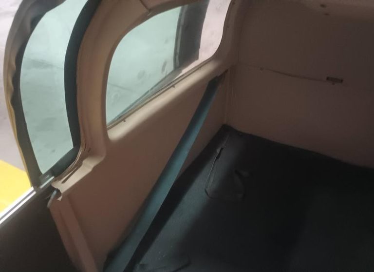 Interior of a vintage car with seatbelt.