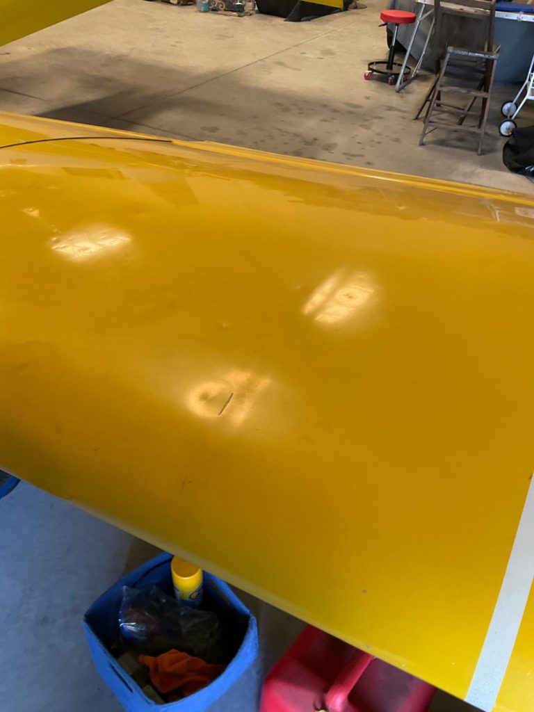 Yellow airplane wing in garage setting