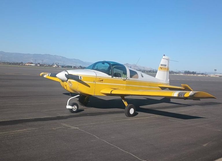 Yellow plane parked on airfield tarmac