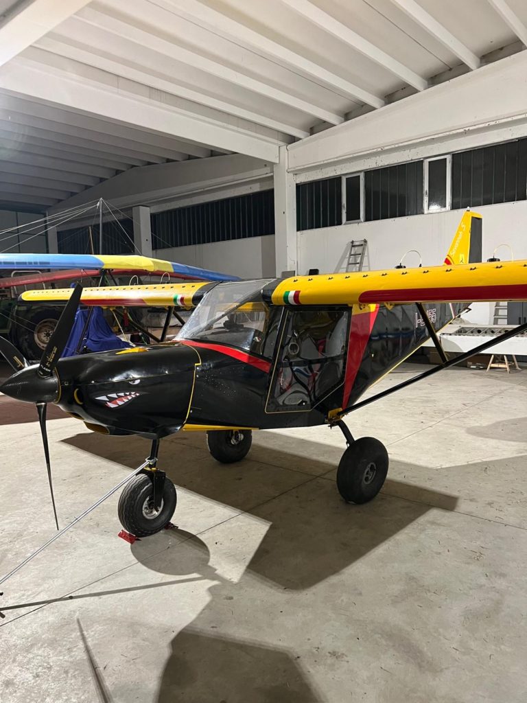 Colorful small airplane in hangar