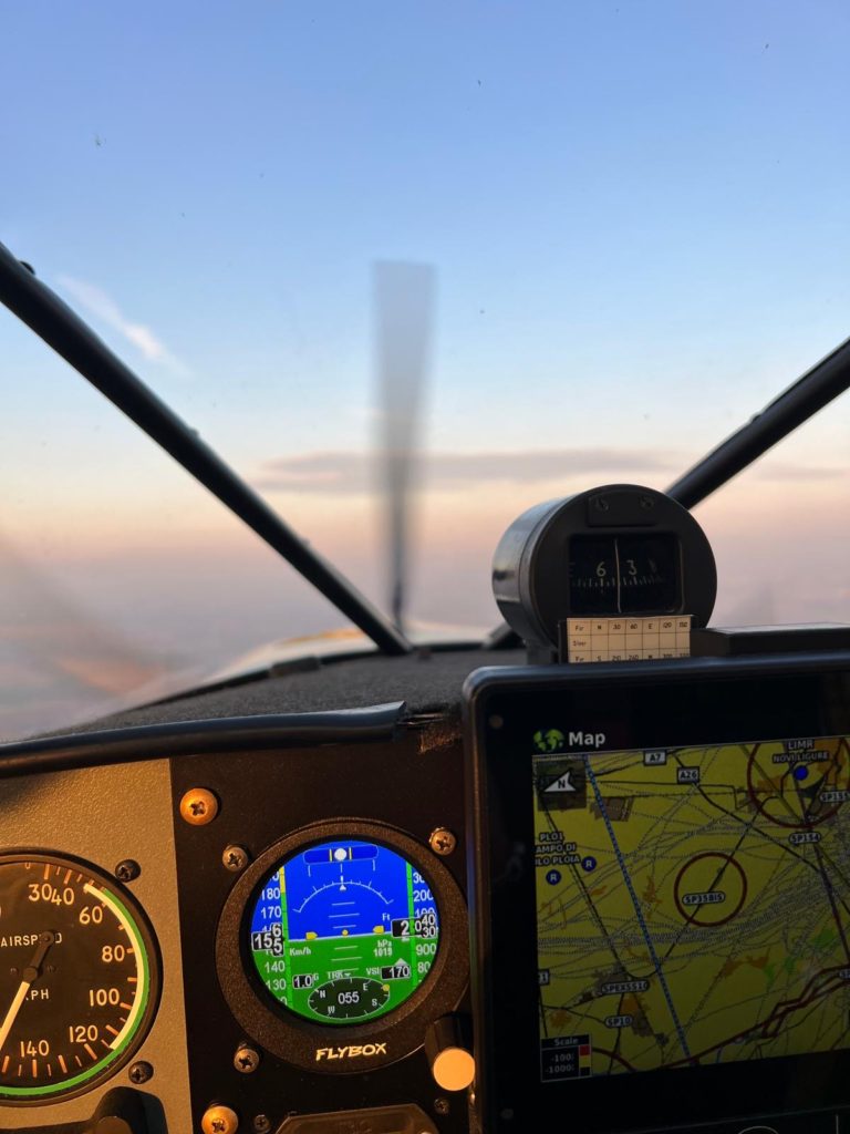 Cockpit view with flight instruments and map display.