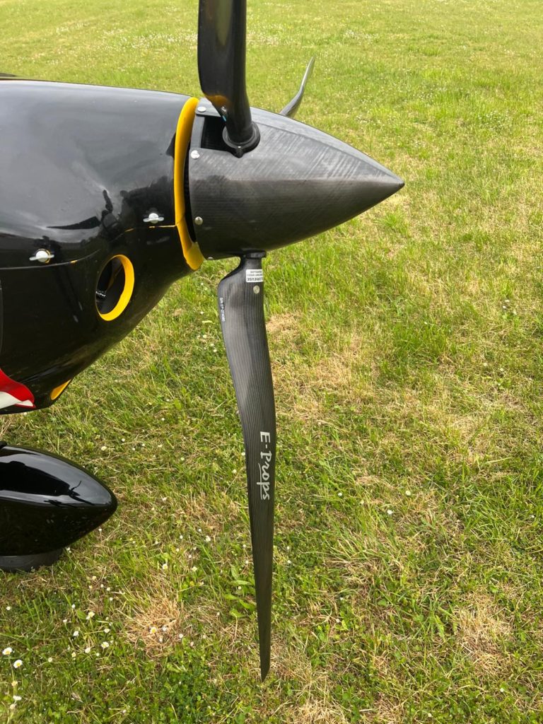 Black propeller on green grass