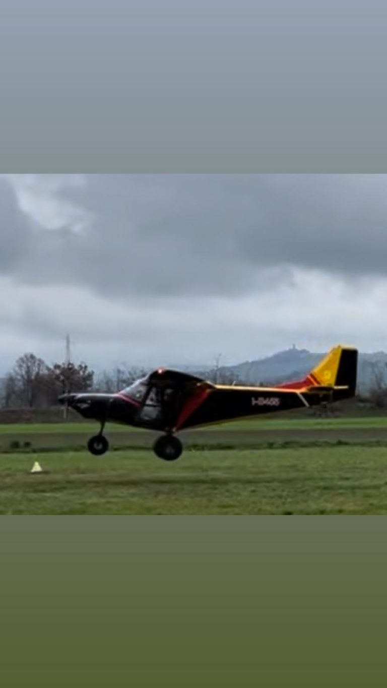 Small plane taking off from a grassy field