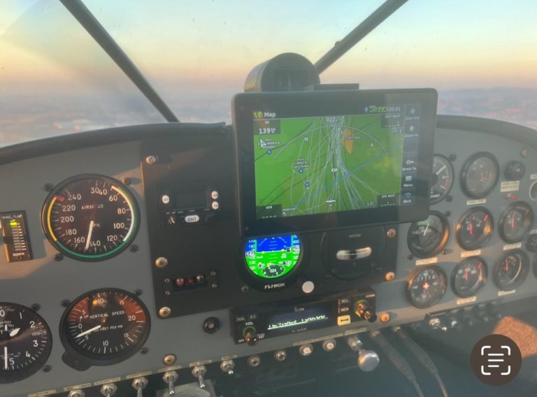 Aircraft cockpit with navigation system and gauges.