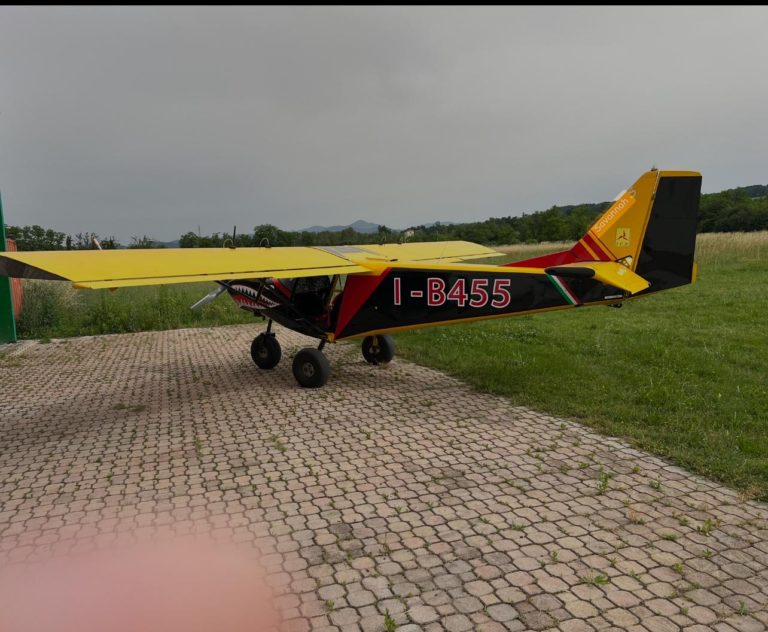Yellow aircraft parked on paved area