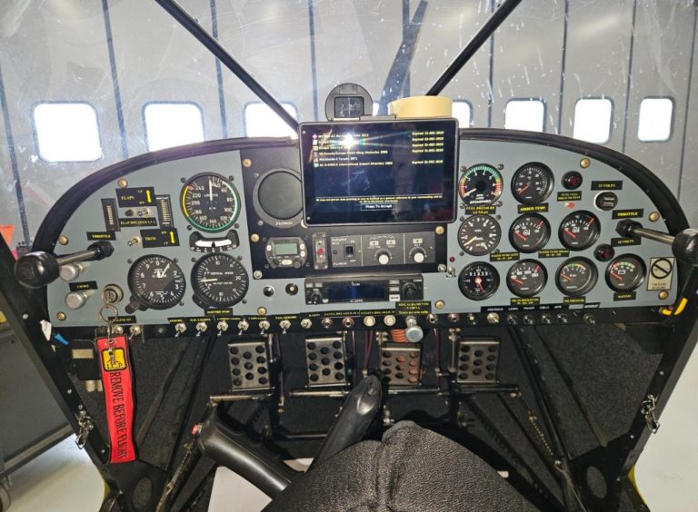 Airplane cockpit with gauges and controls visible.