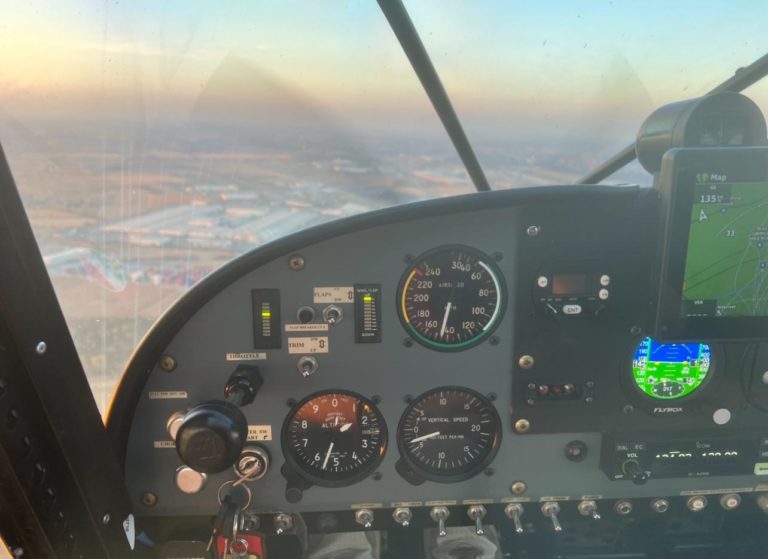 Airplane cockpit instruments with outside landscape view