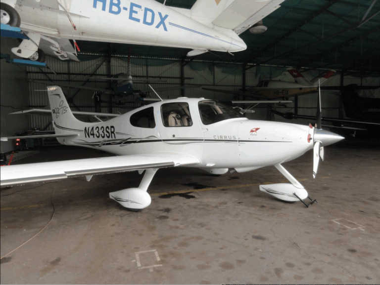 White Cirrus airplane in hangar
