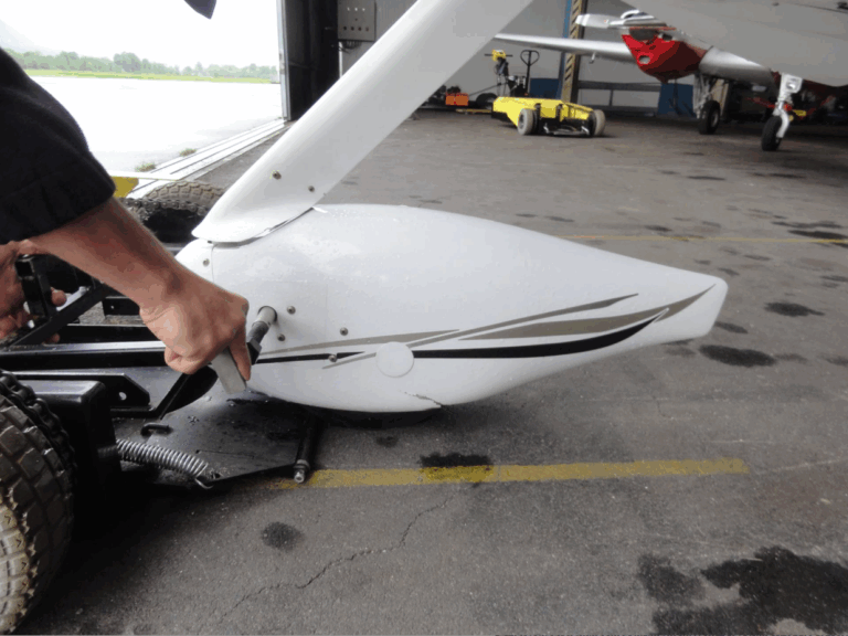 Person securing aircraft wheel inside hangar