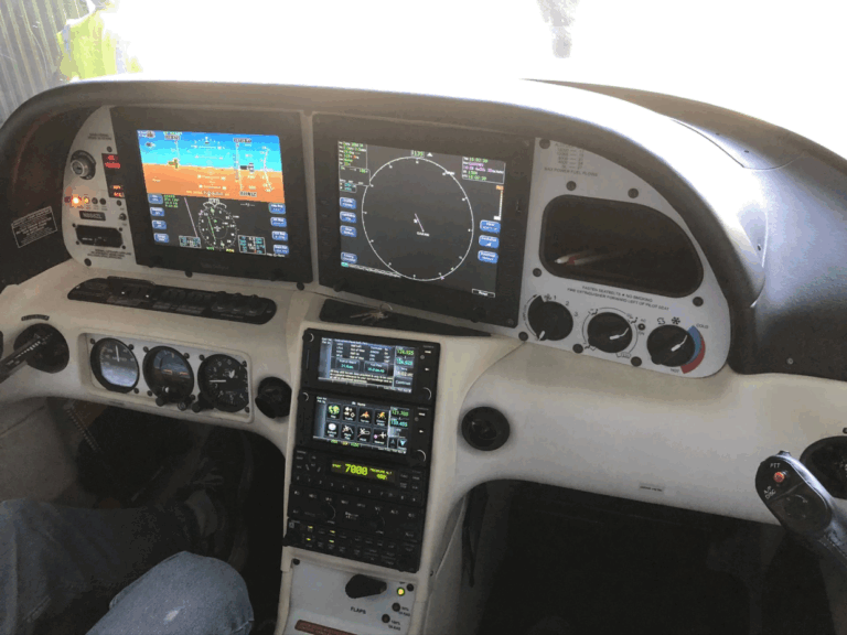 Aircraft cockpit with multiple flight instruments and controls.