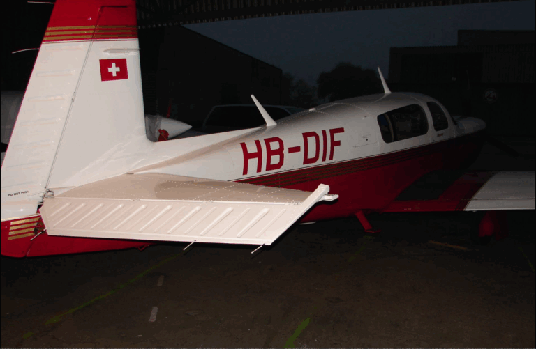 Swiss-registered small aircraft in a hangar.
