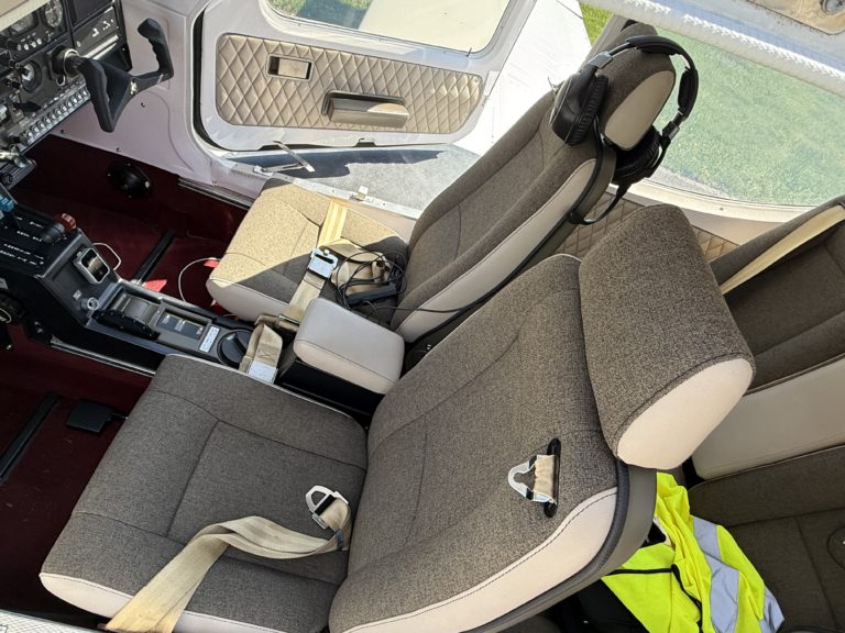 Cessna cockpit interior with seats and controls.