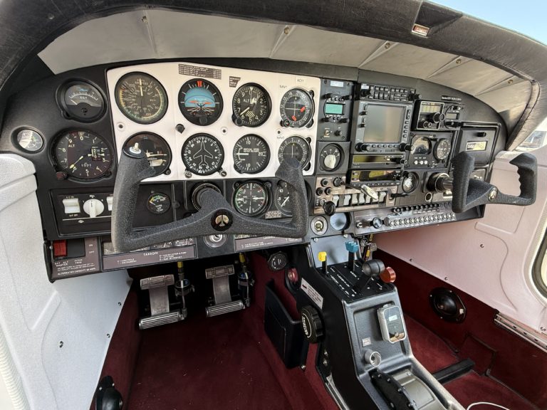 Airplane cockpit with instrument panel and controls.