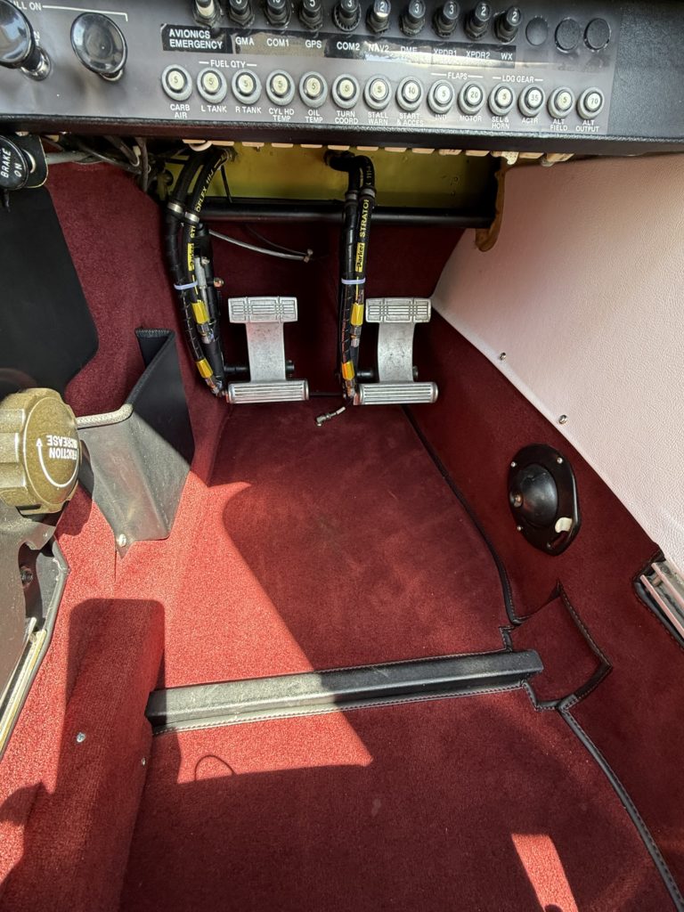 Cockpit foot pedals with control panel above.