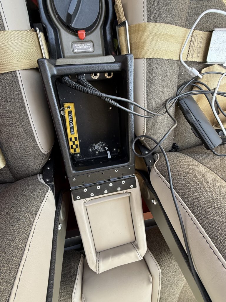 Cockpit center console with seatbelts and cables
