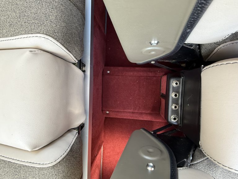 Vehicle seat with red carpeted floor