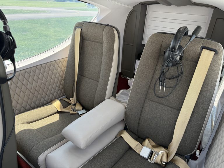 Private airplane interior with two seats and headset.