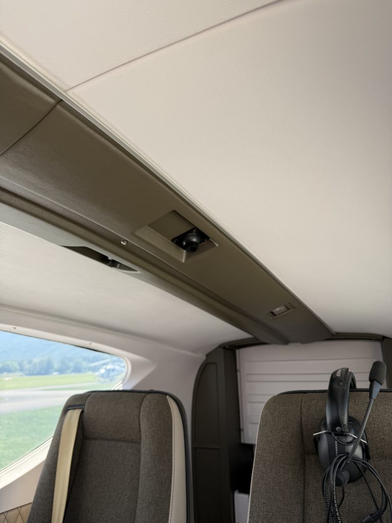 Interior of a small airplane with seats and headset.