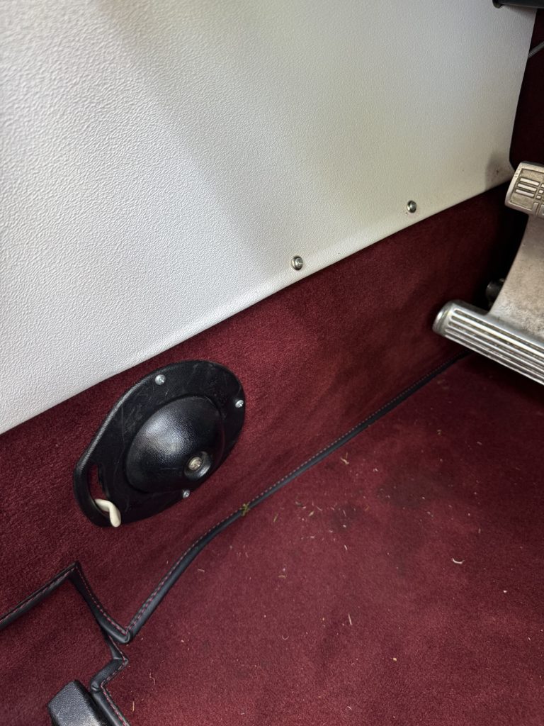 Car interior floor with burgundy carpet