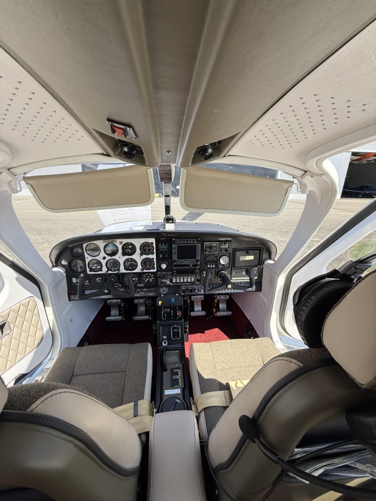 Small aircraft cockpit interior with control panels visible.