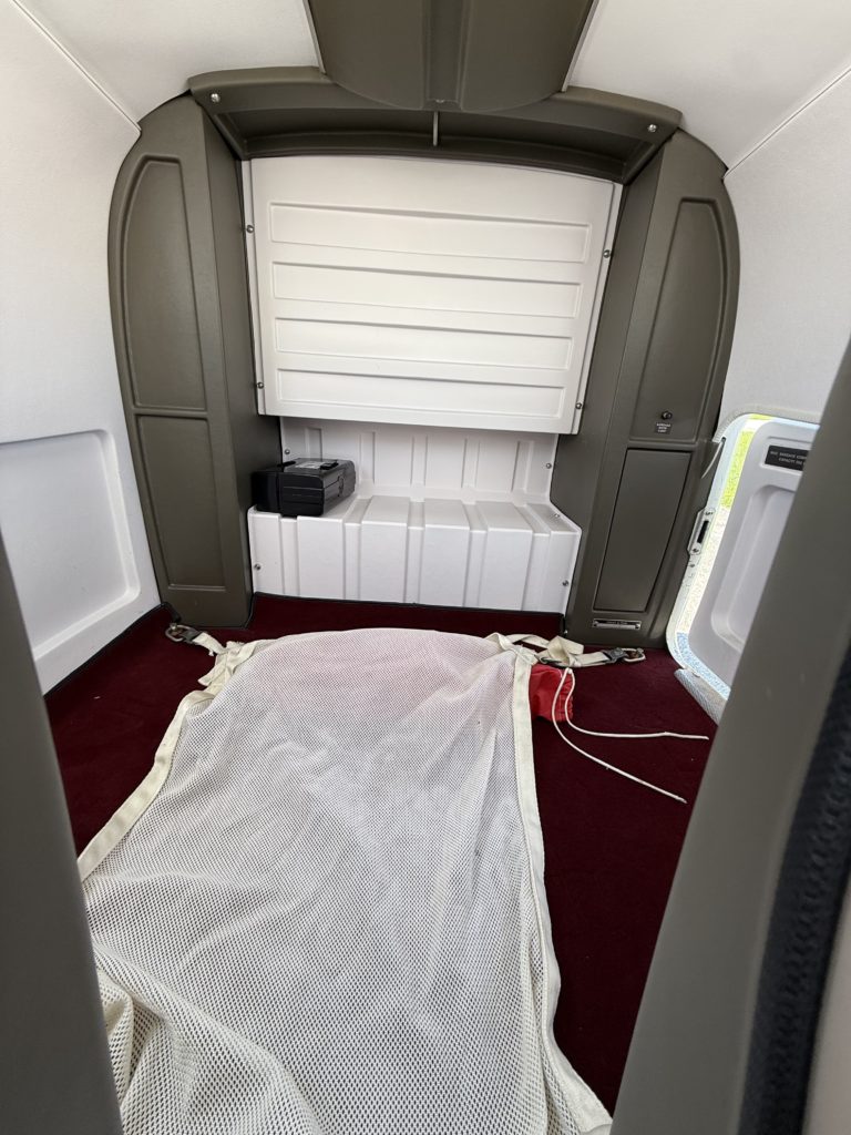 Small aircraft interior with safety net.