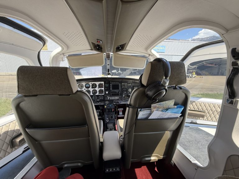 Cockpit interior of small airplane with headset.