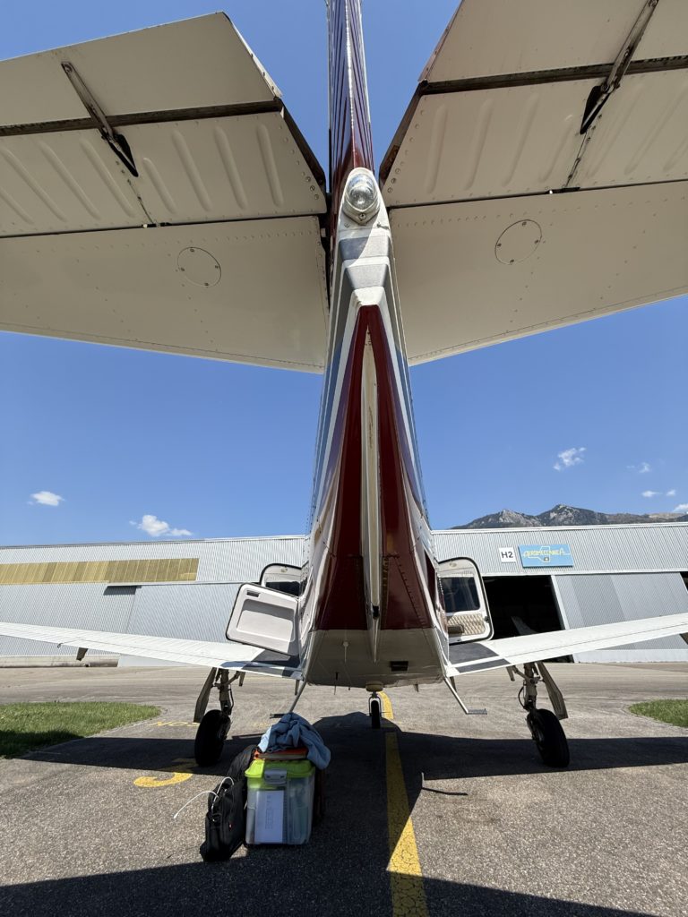 Airplane tail with luggage on tarmac