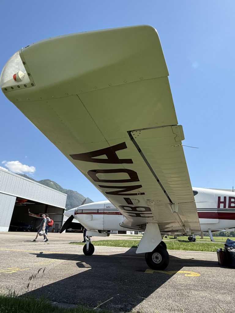 Small airplane on airfield with clear sky