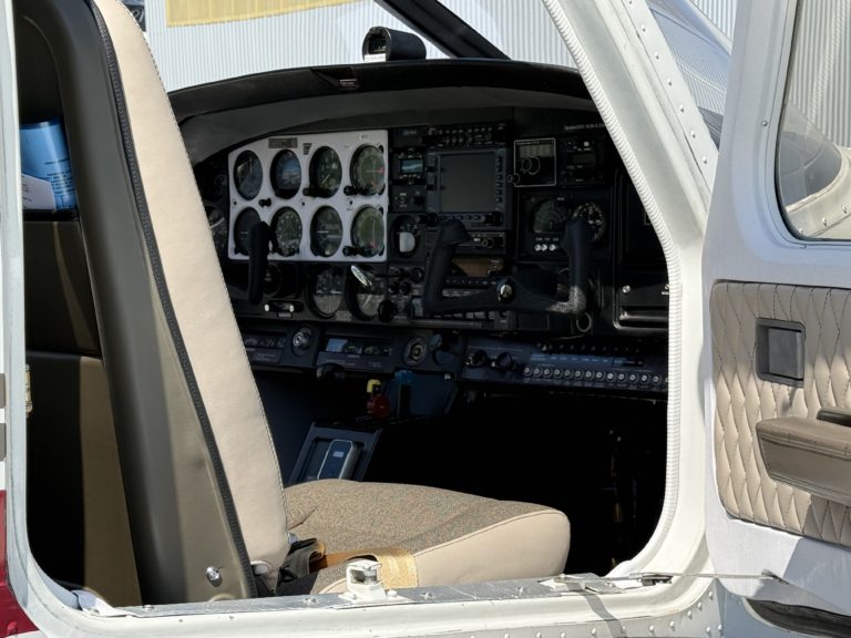 Small aircraft cockpit interior with control panel visible.