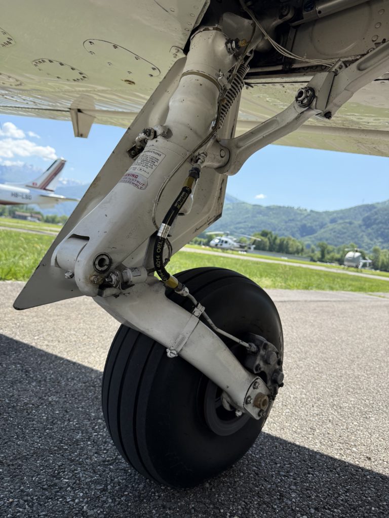 Close-up of airplane landing gear on runway