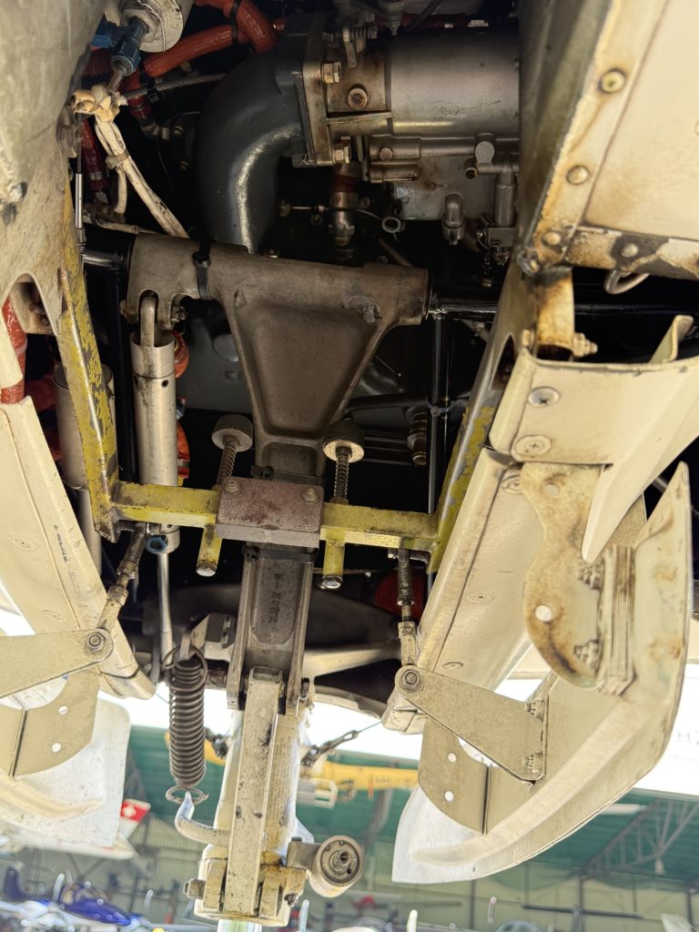 Underside view of mechanical aircraft components.