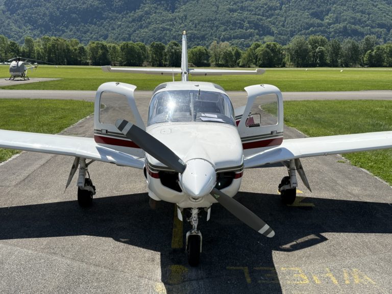 Small airplane parked on a grassy airfield