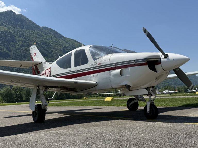Small plane on runway near mountains