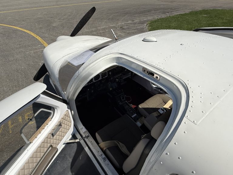 Small airplane cockpit seen through open door