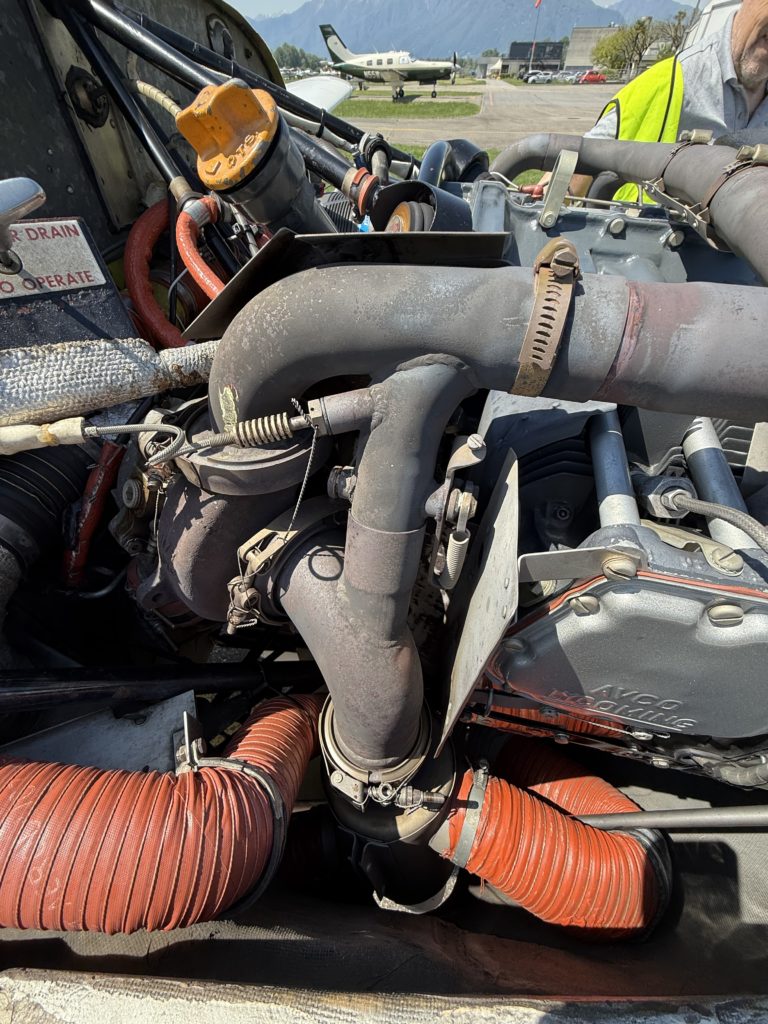 Closeup of small aircraft engine on display.